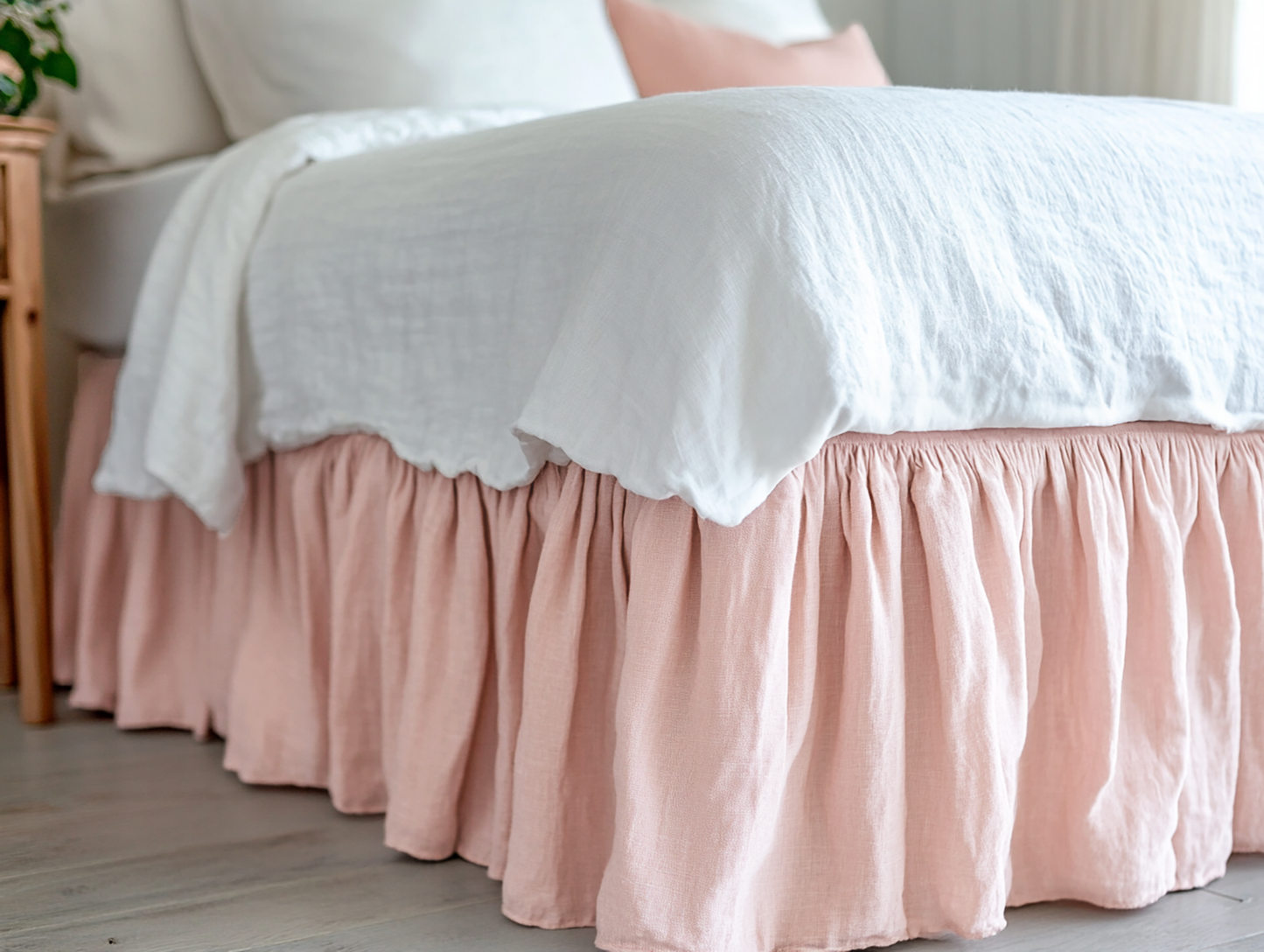 Light pink ruffled bed skirt